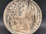 a black and white plate with an image of a woman holding a child