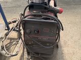 a machine that is sitting on the ground in the garage