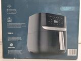 an image of a black and silver air fryer sitting on top of a counter