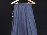 the skirt is hanging on a clothes rack on a clothes line