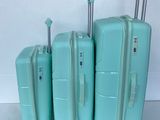three pieces of luggage sitting on top of each other on a white surface