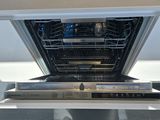 a dishwasher that is open on the counter