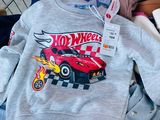 a pile of clothes with a hot wheels shirt on it