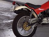 a red and white motorcycle parked in a garage