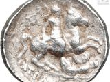 an image of a silver coin with an image of a man on a horse