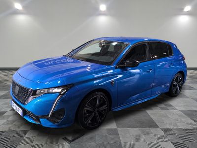 a blue car parked in a garage with a checkered floor