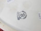 a close up of a white plate with a flower on it