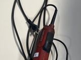 a red electric drill with a cord attached to it