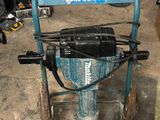 a blue machine that is sitting in a garage