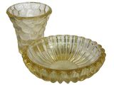 a glass bowl and a glass cup sitting on a plate