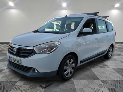 the small white car is parked in a room with a checkered floor