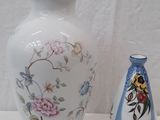 two vases sitting next to each other on a table
