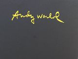 a close up of a black book with yellow writing on it