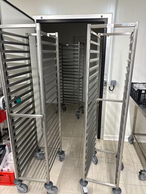 a metal rack that has a bunch of trays on it