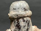 statue of a man wearing a helmet and holding something in his hand