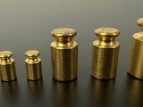 a close up of a group of brass knobs on a table