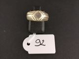 a close up of a ring with a price tag on a table