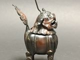 a statue of a dog holding a fish in its mouth