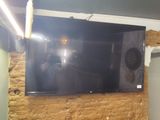 a large flat screen tv mounted on a brick wall