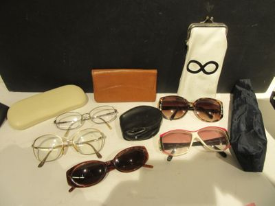 a table with sunglasses, a purse, and other items on it