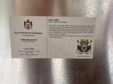 a business card with a picture of a coat of arms on it