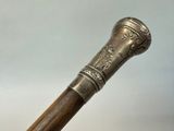 a close up of an old walking stick on a table