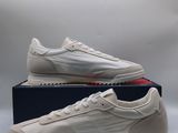 a pair of white sneakers sitting on top of a box