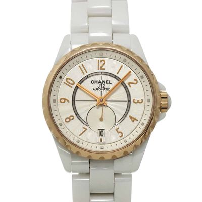 a white watch with gold hands on a white bracelet