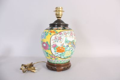 a lamp that is sitting on a table next to a flower vase
