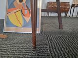 a picture of a cat that is sitting under a table