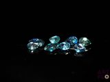 some very pretty blue diamonds on a black surface