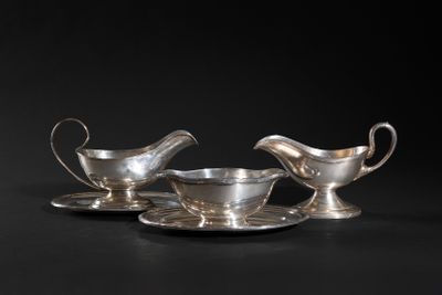 a pair of silver plated saucers and saucers on a black background
