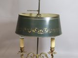 a lamp that has a green shade on it