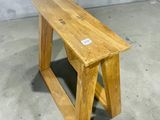 a wooden bench with a sticker on the top of it