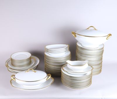 a lot of white and gold plates and cups