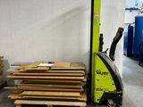 a forklift with pallets of wood in a warehouse