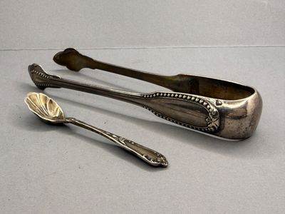two spoons and a spoon rest next to each other on a table