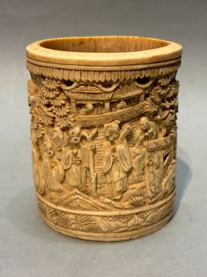 an image of a carved cup with a scene of people in a boat