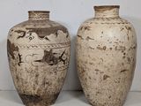 two vases sitting next to each other on a table