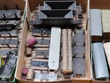 a box with a bunch of different types of toy trains in it