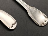 two spoons and a spoon on a black surface
