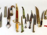 many knives that are lined up on the wall