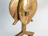brass sculpture of a man ' s head on a wooden base