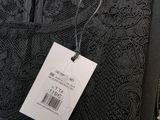 a close up of a black dress with a price tag on it