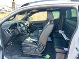 the interior of a car with the door open and the driver ' s seat down