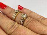 someone is showing off their wedding rings with a red manicure