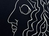 a black and white drawing of a woman ' s face with long hair