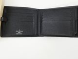 a black leather wallet sitting on top of a white table