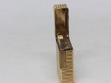 an image of a gold colored hair comb on a white surface