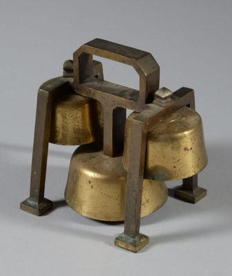 two bells that are sitting on top of each other